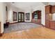 Spacious living room with wood and carpet flooring and featuring custom wood built-ins, and exterior doors and windows at 1423 & 1435 Hillview Dr, Sarasota, FL 34239