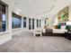A spacious main bedroom boasts an en suite bathroom, seating, and large windows framing scenic waterfront vistas at 1423 & 1435 Hillview Dr, Sarasota, FL 34239