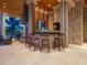 Covered outdoor kitchen with brick accents, bar seating, and fireplace at 1423 & 1435 Hillview Dr, Sarasota, FL 34239