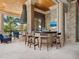 Covered outdoor kitchen with brick accents, bar seating, and fireplace at 1423 & 1435 Hillview Dr, Sarasota, FL 34239