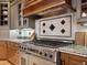 Close-up of gas range with custom backsplash and hardwood floors at 1423 & 1435 Hillview Dr, Sarasota, FL 34239
