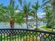 A picturesque waterfront view is seen from a balcony, highlighting lush greenery, private docks, and serene waters at 1423 & 1435 Hillview Dr, Sarasota, FL 34239