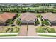 Beautiful aerial view of single Gathering homes featuring lush landscaping and brick paver driveways in a planned community at 15752 Sacile Ln, Bradenton, FL 34211