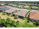 Aerial view of a residential community, complete with manicured lawns and a serene waterway at 15752 Sacile Ln, Bradenton, FL 34211