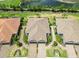 Beautiful aerial view of single Gathering homes featuring lush landscaping and brick paver driveways in a planned community at 15752 Sacile Ln, Bradenton, FL 34211