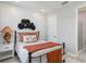 Relaxing bedroom with shiplap accent wall, metal bed frame, and a door leading to bathroom at 15752 Sacile Ln, Bradenton, FL 34211