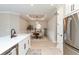 Open-concept space featuring a kitchen flowing into a dining area with modern decor and stainless steel appliances at 15752 Sacile Ln, Bradenton, FL 34211