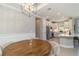 Bright dining area with a modern chandelier adjacent to a well-equipped kitchen with stainless steel appliances at 15752 Sacile Ln, Bradenton, FL 34211