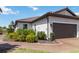 Charming home with tile roof, lush landscaping, and brick paver driveway at 15752 Sacile Ln, Bradenton, FL 34211