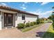 Inviting home entrance with brick pavers and landscaped garden at 15752 Sacile Ln, Bradenton, FL 34211
