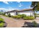 Lovely home exterior featuring a tile roof, lush landscaping and a brick walkway at 15752 Sacile Ln, Bradenton, FL 34211