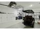 Organized garage with storage cabinets, work area, and a golf cart at 15752 Sacile Ln, Bradenton, FL 34211