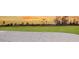 Golf course with a sand trap under an orange sunset sky at 15752 Sacile Ln, Bradenton, FL 34211