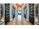 Hallway with wood floors, locker-lined walls, decorative mirrors, and modern lighting at 15752 Sacile Ln, Bradenton, FL 34211