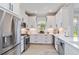 Well-lit kitchen with white cabinets, stainless steel appliances, and elegant countertops at 15752 Sacile Ln, Bradenton, FL 34211