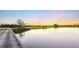 Picturesque view of a serene lake reflecting a vibrant sunset near a golf course at 15752 Sacile Ln, Bradenton, FL 34211