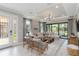 Bright living room featuring stylish furniture, modern lighting, and sliding glass doors at 15752 Sacile Ln, Bradenton, FL 34211
