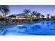 An outdoor pool with lounge chairs, umbrellas, and a bar for drinks at 15752 Sacile Ln, Bradenton, FL 34211