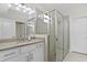 Bathroom featuring granite countertop vanity and frameless glass enclosed shower at 16012 Sunny Day Dr, Bradenton, FL 34211