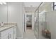 Bathroom features vanity, glass enclosed shower, and adjoins the primary bedroom at 16012 Sunny Day Dr, Bradenton, FL 34211