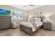 Comfortable bedroom with wood floors, plantation shutters, and well-appointed furnishings at 16012 Sunny Day Dr, Bradenton, FL 34211