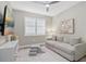 Cozy bedroom with a gray sofa, playful decor, and a serene atmosphere at 16012 Sunny Day Dr, Bradenton, FL 34211