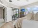 Well-lit bedroom includes wood floors, sliding glass doors to patio, and chest of drawers at 16012 Sunny Day Dr, Bradenton, FL 34211