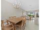 Open dining area with wooden table and chairs, with an elegant chandelier at 16012 Sunny Day Dr, Bradenton, FL 34211