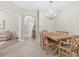 Inviting dining room featuring a wooden table and chandelier, connected to other rooms at 16012 Sunny Day Dr, Bradenton, FL 34211