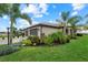 Well-maintained front yard featuring lush tropical landscaping and a two-car garage at 16012 Sunny Day Dr, Bradenton, FL 34211