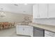 Bright kitchen with white cabinets, granite countertops, stainless appliances open to the dining and living room at 16012 Sunny Day Dr, Bradenton, FL 34211