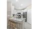 Modern kitchen with stainless steel appliances, granite countertops, and white cabinets at 16012 Sunny Day Dr, Bradenton, FL 34211