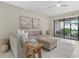 Cozy living room with neutral tones, comfortable seating, and access to an outdoor patio at 16012 Sunny Day Dr, Bradenton, FL 34211