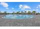 A large community pool surrounded by palm trees offers a relaxing retreat for residents at 16012 Sunny Day Dr, Bradenton, FL 34211