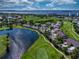 Aerial view of property showcasing lake, golf course, and lush landscaping in beautiful community at 1612 Fairway Oaks Dr, Palmetto, FL 34221