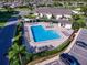 Aerial view of a sparkling community pool surrounded by lounge chairs and lush landscaping at 1612 Fairway Oaks Dr, Palmetto, FL 34221