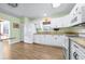 Well-lit kitchen features white cabinetry, granite countertops, and stainless steel appliances at 1612 Fairway Oaks Dr, Palmetto, FL 34221