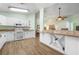 Bright kitchen featuring white cabinets, granite countertops, wine rack, and modern appliances at 1612 Fairway Oaks Dr, Palmetto, FL 34221