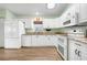 Well-lit kitchen features white cabinetry, granite countertops, and stainless steel appliances at 1612 Fairway Oaks Dr, Palmetto, FL 34221