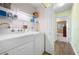 Laundry room with a side-by-side washer and dryer, wire rack shelving, and hardwood floors at 1612 Fairway Oaks Dr, Palmetto, FL 34221