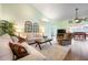 Inviting living room with comfortable seating, modern decor, and an open view to the dining area at 1612 Fairway Oaks Dr, Palmetto, FL 34221
