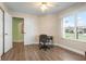 Office area featuring hard wood flooring, a desk, office chair, closet, and natural light at 1612 Fairway Oaks Dr, Palmetto, FL 34221