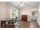 Office room featuring hard wood flooring, a desk, office chair, and access to a bathroom at 1612 Fairway Oaks Dr, Palmetto, FL 34221