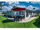 Charming outdoor patio with a table, chairs, and an umbrella, perfect for relaxing or entertaining at 1612 Fairway Oaks Dr, Palmetto, FL 34221