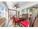 Bright sunroom featuring a ceiling fan, multiple windows, and a dining table with seating at 1612 Fairway Oaks Dr, Palmetto, FL 34221