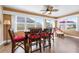 Bright sunroom featuring a ceiling fan, multiple windows, and a dining table with seating at 1612 Fairway Oaks Dr, Palmetto, FL 34221