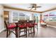 Bright sunroom featuring a ceiling fan, multiple windows, and a dining table with seating at 1612 Fairway Oaks Dr, Palmetto, FL 34221
