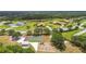 A high-angle view of a recreational area with a playground, picnic shelter, and sports courts at 16246 26Th E St, Parrish, FL 34219