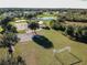 Aerial of a community park featuring a basketball court, pond, and grassy fields at 16246 26Th E St, Parrish, FL 34219
