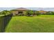 Large green backyard featuring lush lawn and landscaping, including palm trees at 16246 26Th E St, Parrish, FL 34219